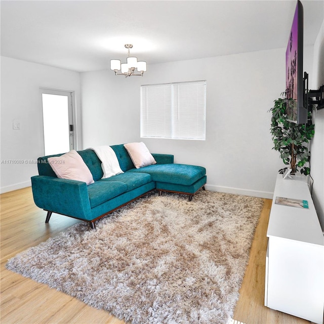 living room featuring hardwood / wood-style flooring and a notable chandelier