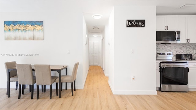 dining space with light wood-type flooring