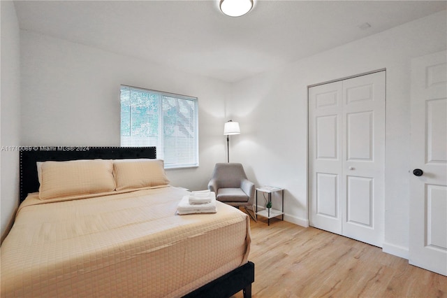 bedroom featuring a closet and light hardwood / wood-style flooring