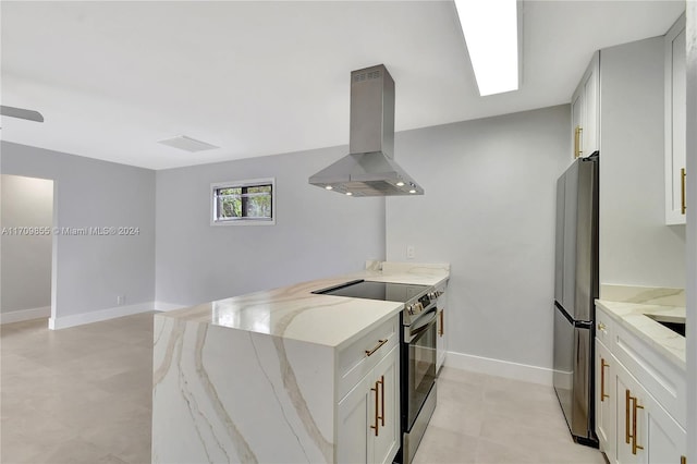 kitchen featuring kitchen peninsula, light stone counters, ventilation hood, stainless steel appliances, and white cabinets