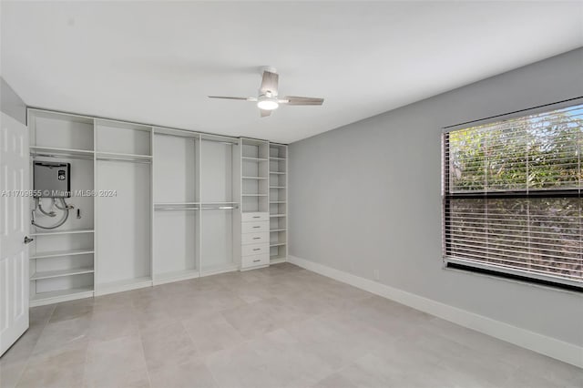 unfurnished bedroom featuring ceiling fan and a closet