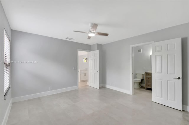 unfurnished bedroom featuring ensuite bathroom and ceiling fan