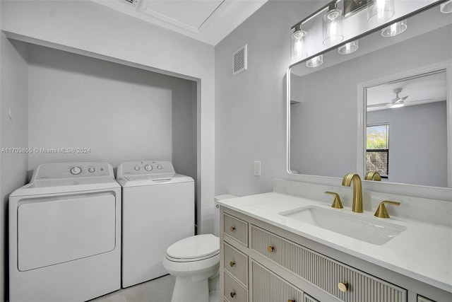 bathroom with washing machine and clothes dryer, ceiling fan, tile patterned floors, toilet, and vanity