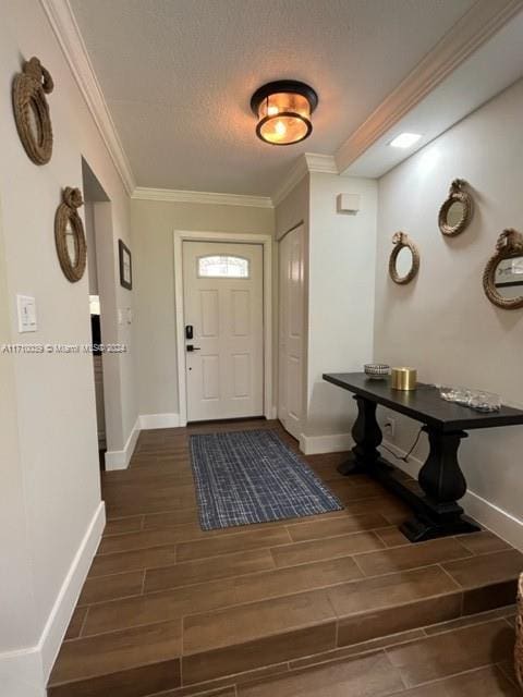 foyer featuring a textured ceiling and crown molding