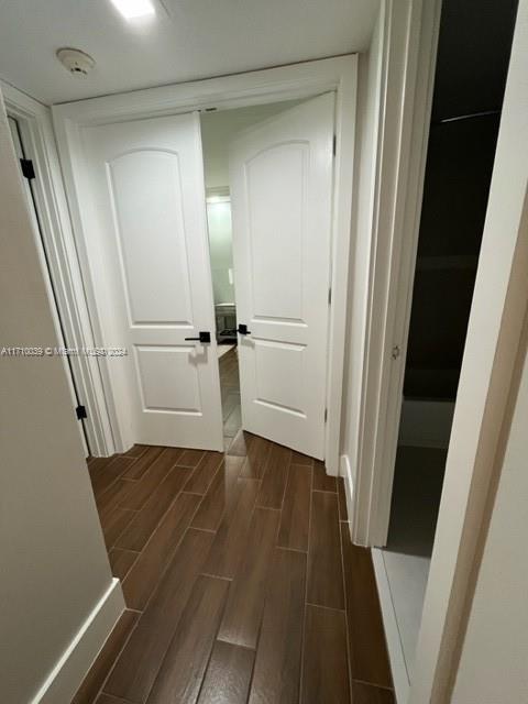 hall with dark hardwood / wood-style floors