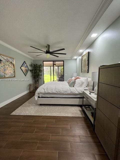 bedroom with crown molding, ceiling fan, and dark wood-type flooring