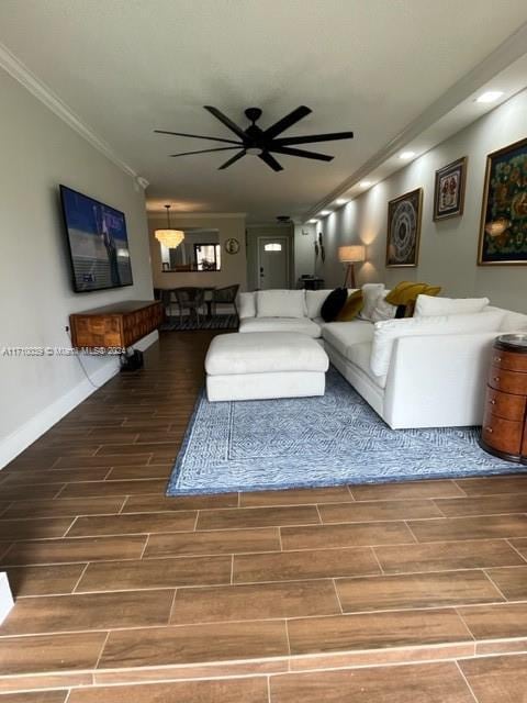 living room featuring ceiling fan and ornamental molding