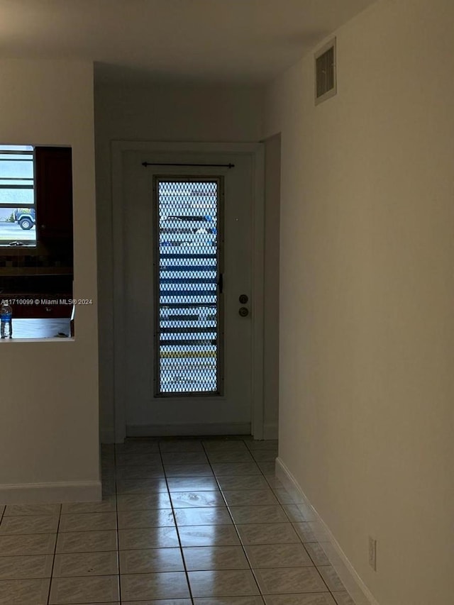 doorway with tile patterned floors