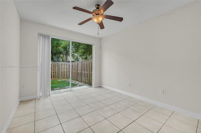 spare room featuring light tile patterned floors and ceiling fan