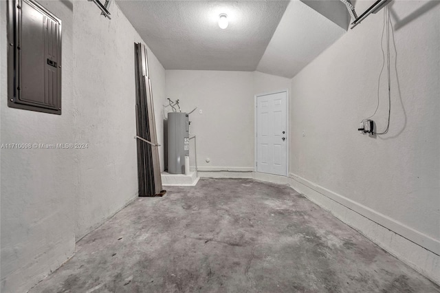 garage featuring electric panel and water heater