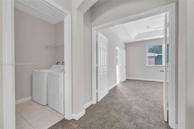 laundry area with washer and dryer and light colored carpet