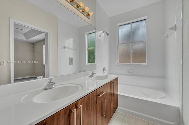 bathroom featuring tile patterned flooring, vanity, and a bathtub