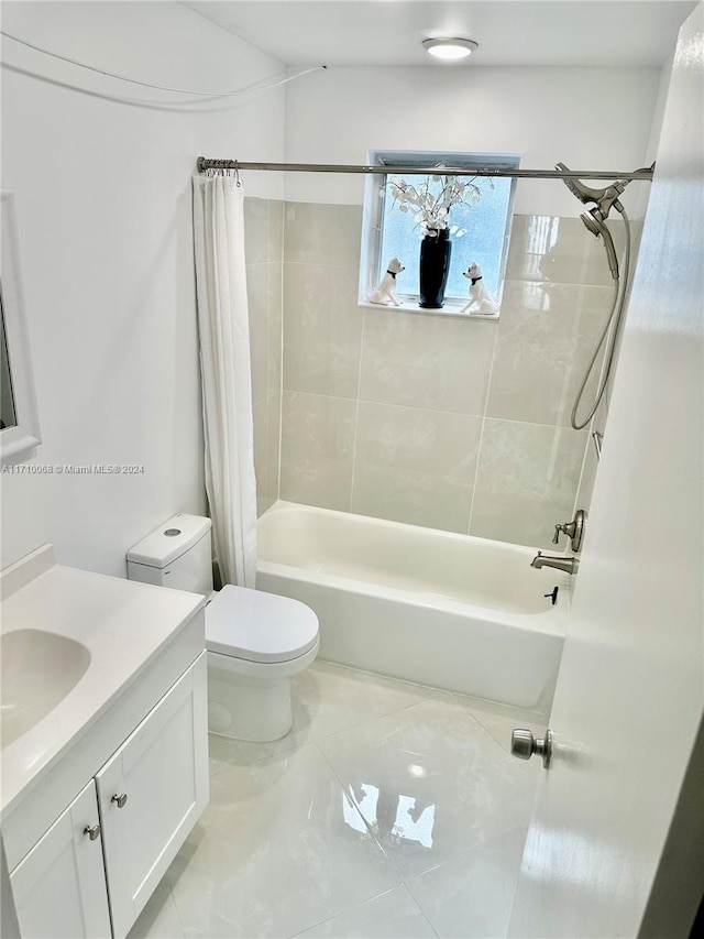 full bathroom featuring shower / bath combo, toilet, and vanity