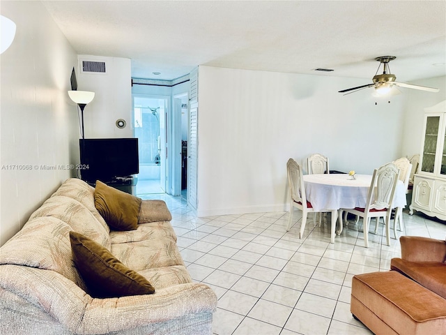 living room featuring ceiling fan and light tile patterned flooring