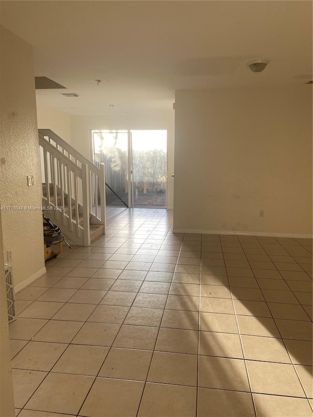 spare room featuring light tile patterned floors