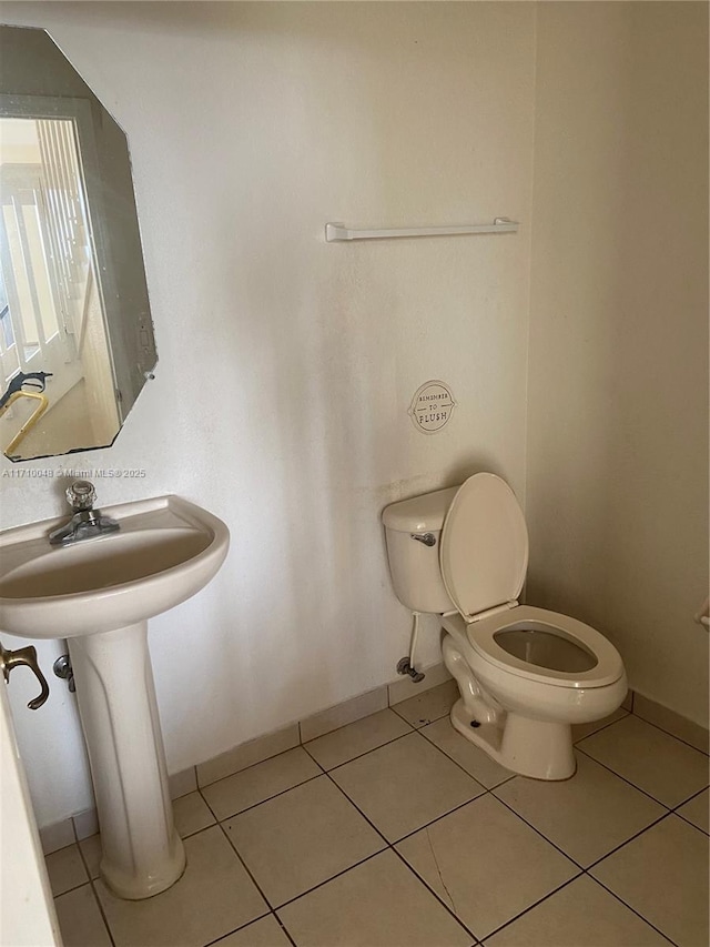 bathroom with tile patterned flooring and toilet