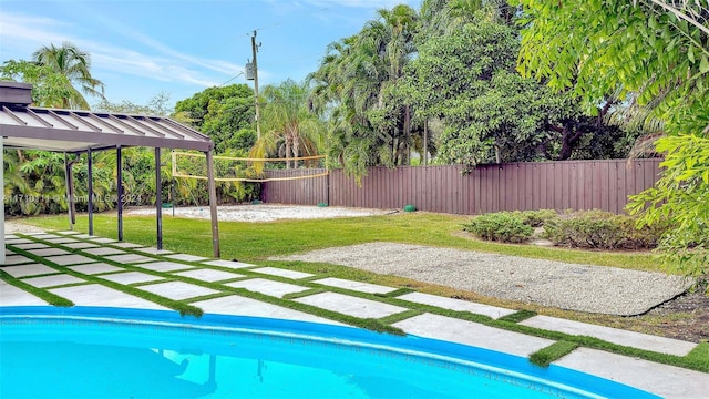 view of swimming pool with a yard