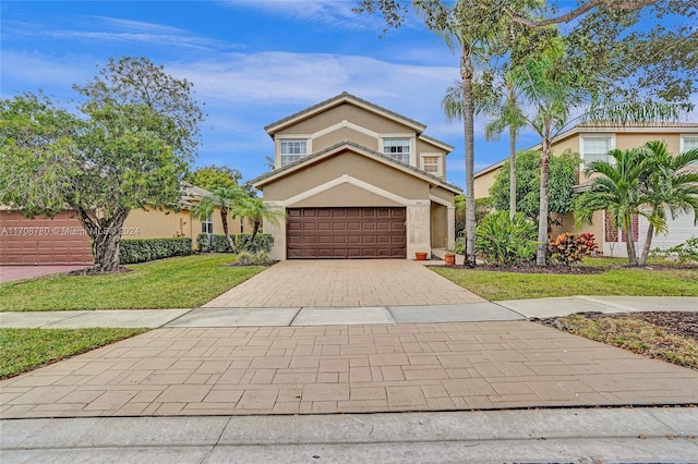 view of front property featuring a front lawn and a garage