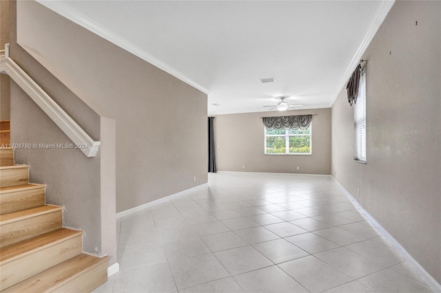 unfurnished room with ceiling fan, light tile patterned floors, and crown molding