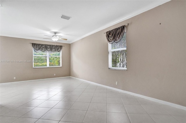 tiled spare room featuring ceiling fan and crown molding