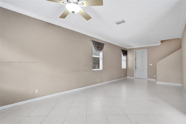 unfurnished room with ceiling fan, light tile patterned floors, and crown molding