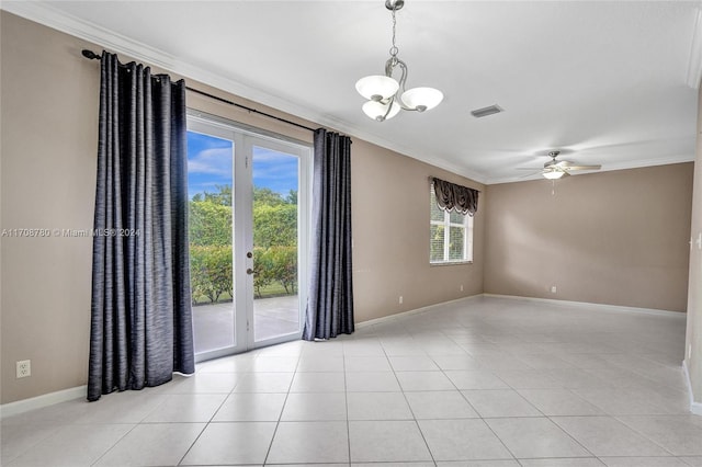 tiled spare room featuring ornamental molding, ceiling fan with notable chandelier, and a healthy amount of sunlight