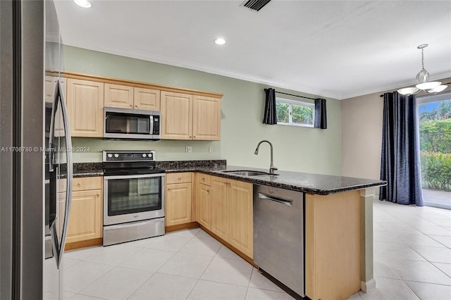 kitchen featuring kitchen peninsula, stainless steel appliances, plenty of natural light, and ornamental molding