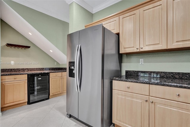 kitchen featuring beverage cooler, stainless steel refrigerator with ice dispenser, dark stone countertops, light tile patterned flooring, and ornamental molding