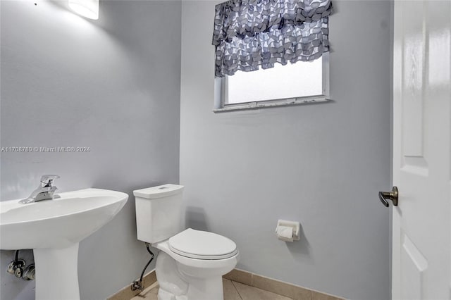 bathroom featuring sink, tile patterned flooring, and toilet