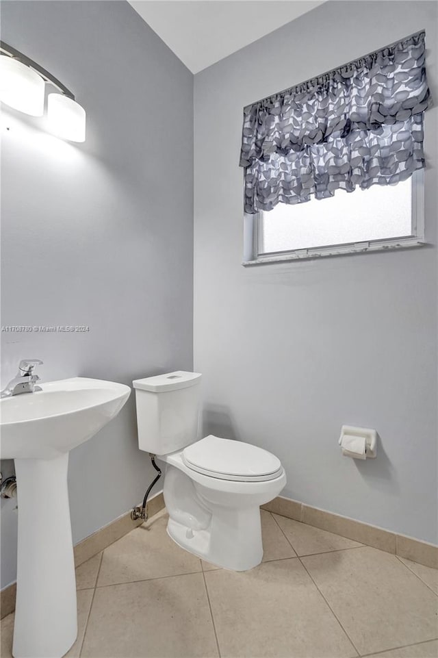 bathroom with tile patterned floors, toilet, and sink