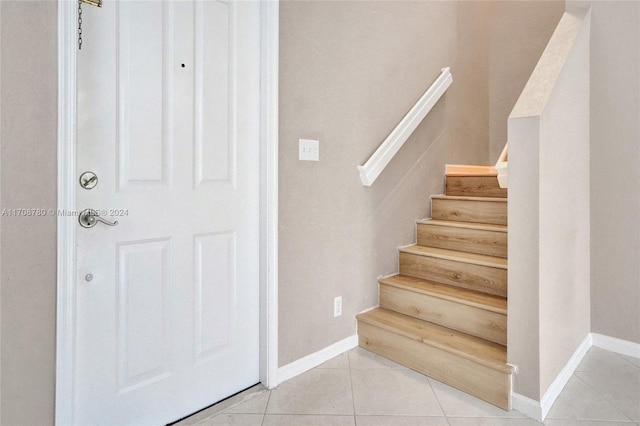 stairs with tile patterned floors