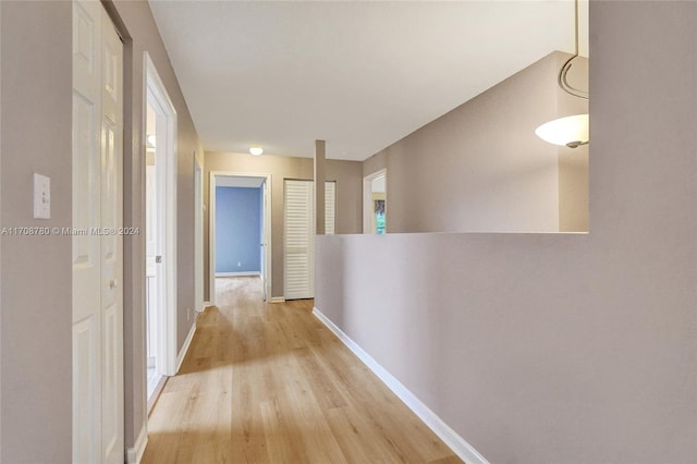 corridor with light hardwood / wood-style flooring