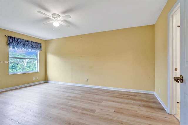 empty room with ceiling fan and light wood-type flooring