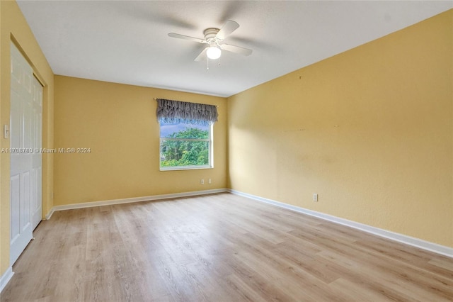 empty room featuring ceiling fan and light wood-type flooring