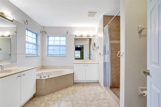 bathroom featuring tile patterned floors, vanity, and plus walk in shower