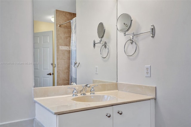 bathroom featuring a shower with curtain, vanity, and lofted ceiling