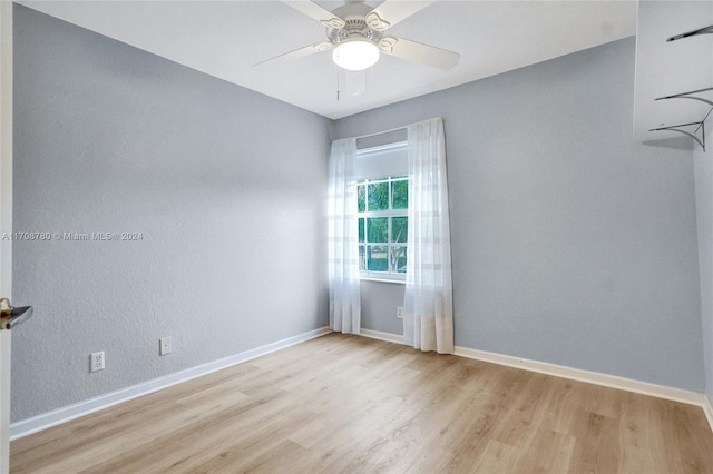 spare room with light wood-type flooring and ceiling fan