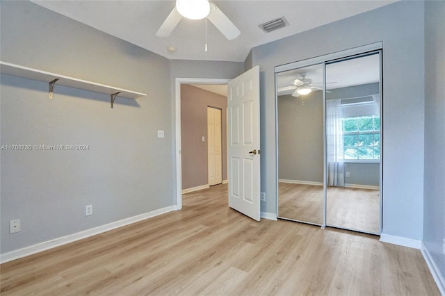 unfurnished bedroom featuring ceiling fan, light wood-type flooring, and a closet