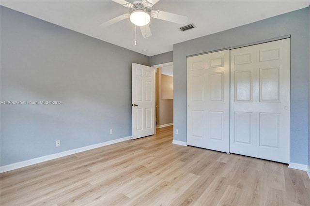 unfurnished bedroom featuring ceiling fan, a closet, and light hardwood / wood-style floors