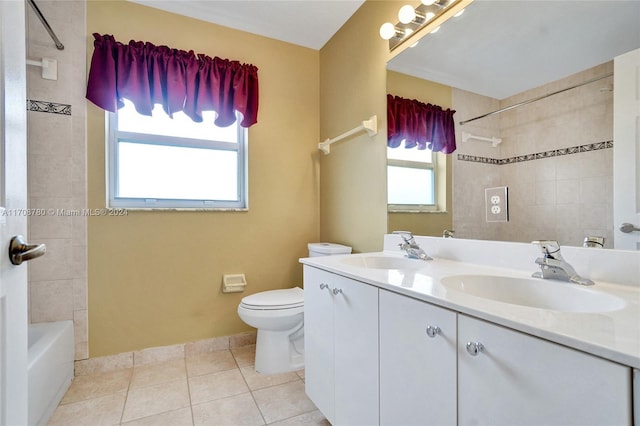 full bathroom featuring tile patterned flooring, vanity, tiled shower / bath combo, and toilet