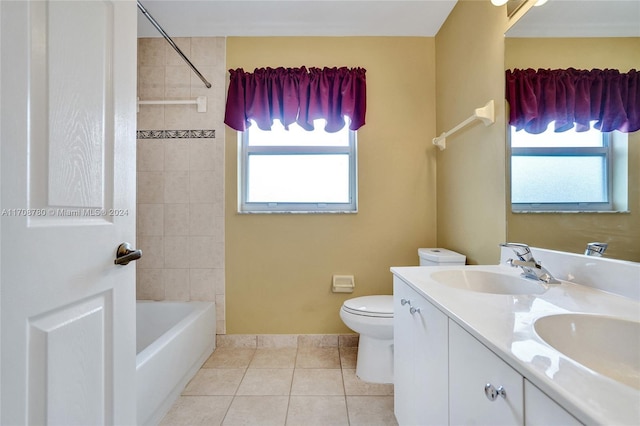 full bathroom with toilet, vanity, tile patterned floors, and a wealth of natural light