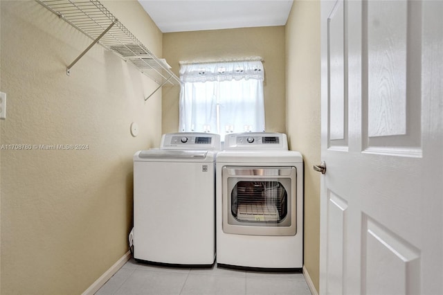 washroom with light tile patterned floors and independent washer and dryer