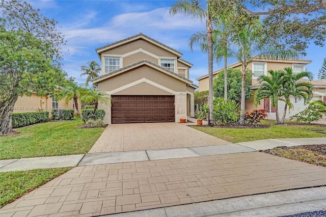 front facade featuring a front lawn and a garage