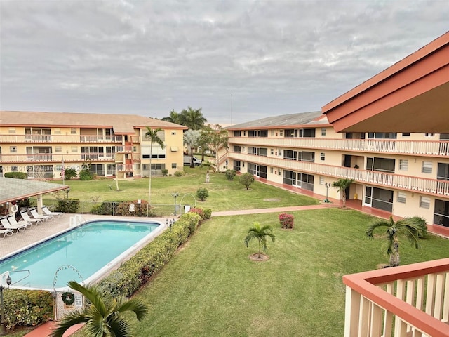 view of pool featuring a patio area and a lawn