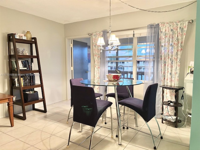 tiled dining area featuring an inviting chandelier