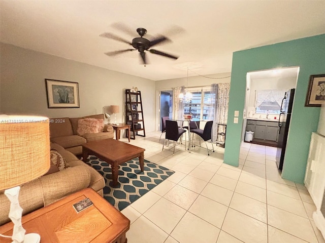 living room featuring ceiling fan and light tile patterned floors