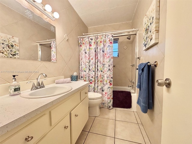 full bathroom with tile patterned floors, tile walls, toilet, vanity, and shower / tub combo