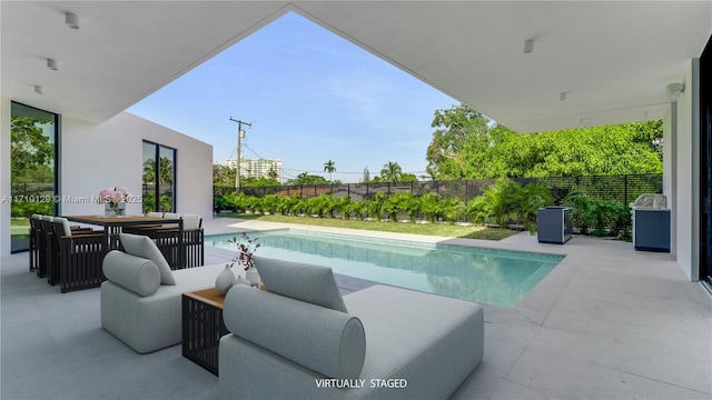 view of pool with a patio area and an outdoor living space