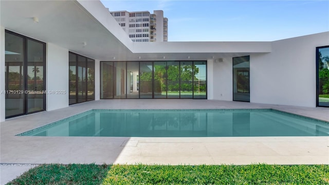 view of swimming pool featuring a patio area