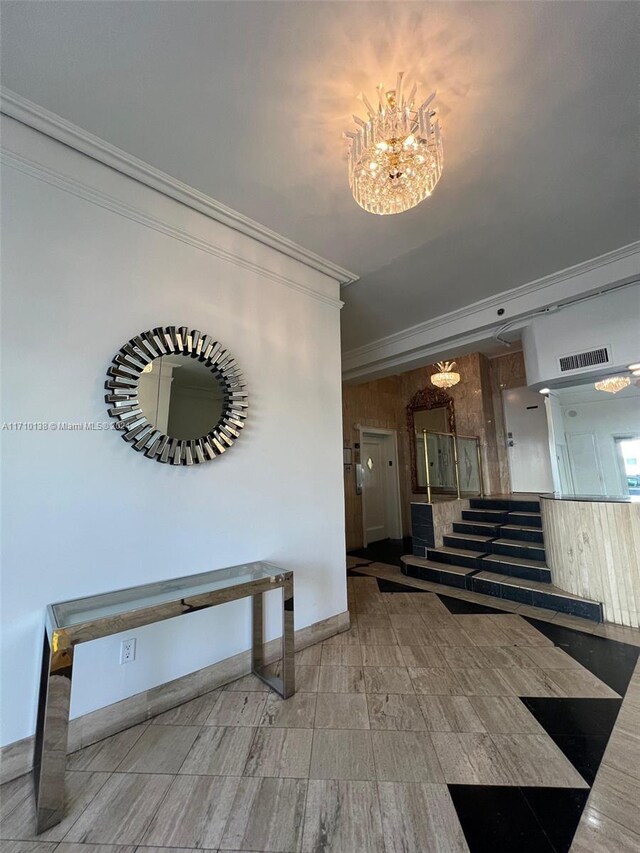 interior space featuring ornamental molding and an inviting chandelier